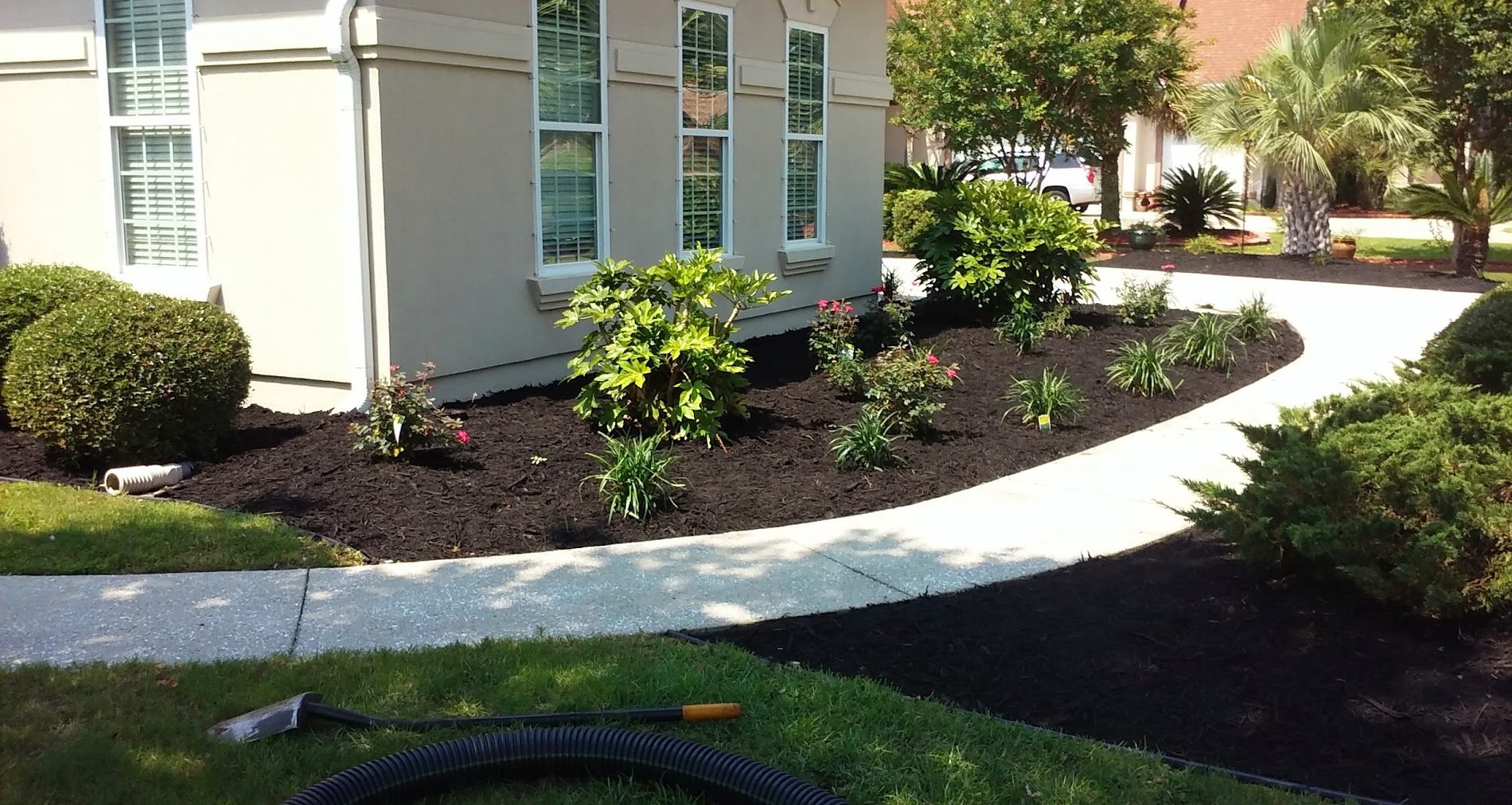 Fresh mulch beds and crisp lawn edging by JR's Landscaping
